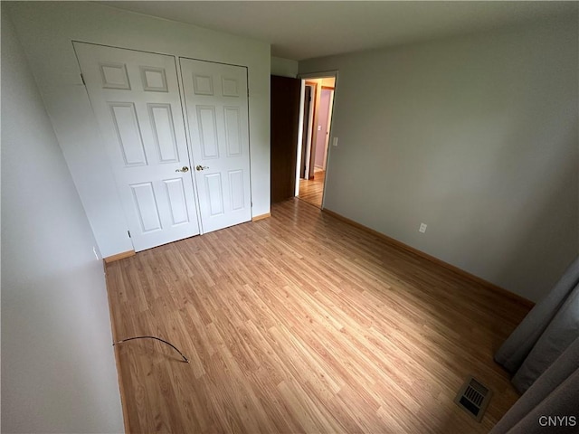 8071 Evesborough Dr, Clay, NY 13041 - unfurnished bedroom featuring light wood-type flooring and a closet