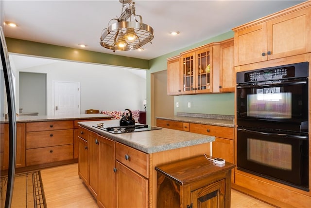 6270 Wolf Run Rd, Campbell, NY 14821 - kitchen with stovetop, a kitchen island, glass insert cabinets, light wood-style flooring, and recessed lighting