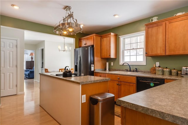 6270 Wolf Run Rd, Campbell, NY 14821 - kitchen with stainless steel fridge, black dishwasher, a kitchen island, a chandelier, and light wood-type flooring