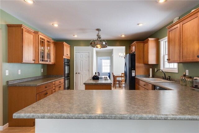 6270 Wolf Run Rd, Campbell, NY 14821 - kitchen featuring black appliances, a center island, a chandelier, glass insert cabinets, and a peninsula
