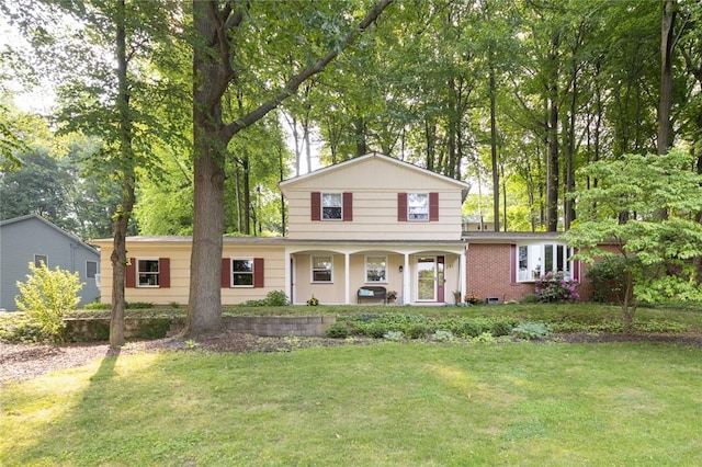 151 Chapel Hill Dr, Irondequoit, NY 14617 - traditional-style house with covered porch and a front yard
