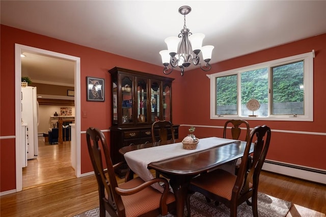 151 Chapel Hill Dr, Irondequoit, NY 14617 - dining area featuring a chandelier and wood finished floors