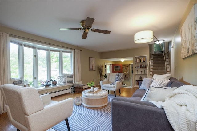 151 Chapel Hill Dr, Irondequoit, NY 14617 - living area featuring ceiling fan, wood finished floors, a baseboard radiator, and stairway