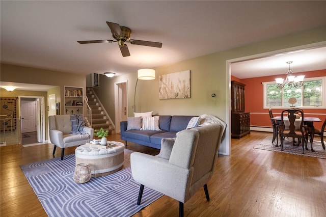 151 Chapel Hill Dr, Irondequoit, NY 14617 - living room featuring baseboard heating, stairs, a chandelier, wood finished floors, and a ceiling fan