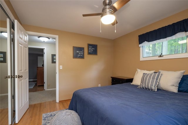 151 Chapel Hill Dr, Irondequoit, NY 14617 - bedroom featuring light wood-style floors, baseboard heating, and a ceiling fan