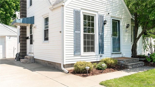 610 Huth Rd, Cheektowaga, NY 14225 - view of side of property featuring entry steps, an outbuilding, a garage, and concrete driveway