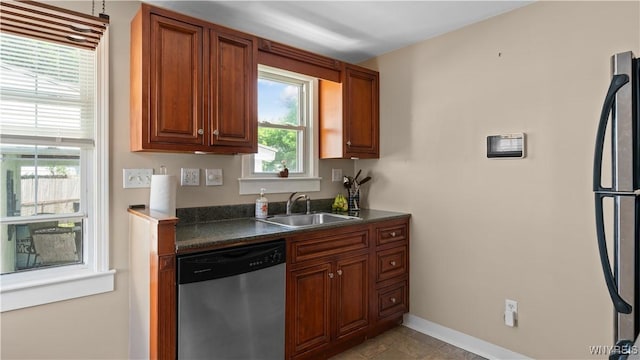 610 Huth Rd, Cheektowaga, NY 14225 - kitchen featuring stainless steel appliances, dark countertops, and brown cabinets