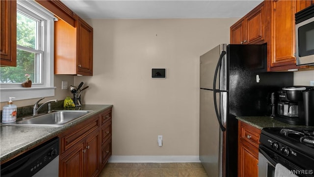 610 Huth Rd, Cheektowaga, NY 14225 - kitchen with stainless steel appliances, dark countertops, and brown cabinets