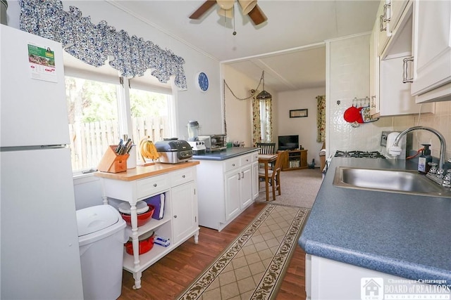 103 Springdale Ave, Jamestown, NY 14701 - kitchen featuring freestanding refrigerator, ceiling fan, white cabinetry, dark wood finished floors, and decorative backsplash