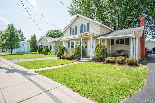 225 Breen Ave, Watertown-City, NY 13601 - view of front of home with a front lawn and a chimney
