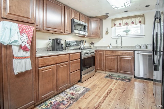 225 Breen Ave, Watertown-City, NY 13601 - kitchen featuring appliances with stainless steel finishes, light countertops, brown cabinets, and light wood-style flooring