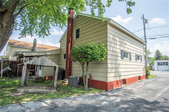 225 Breen Ave, Watertown-City, NY 13601 - view of side of home featuring a chimney and an outdoor structure