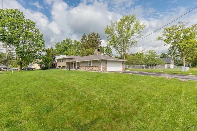 13 Berrywood Rd, Clay, NY 13090 - view of front of house with driveway, a chimney, an attached garage, a front yard, and brick siding