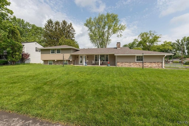 13 Berrywood Rd, Clay, NY 13090 - back of property featuring a chimney, stone siding, and a yard