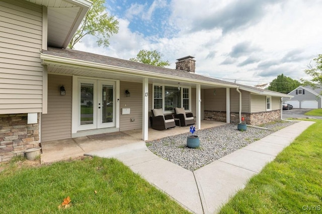 13 Berrywood Rd, Clay, NY 13090 - entrance to property featuring stone siding, a chimney, french doors, outdoor lounge area, and a yard