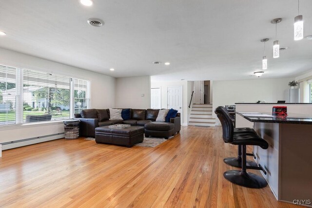 13 Berrywood Rd, Clay, NY 13090 - living area with plenty of natural light, baseboard heating, light wood-style floors, recessed lighting, and stairway