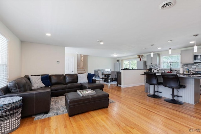 13 Berrywood Rd, Clay, NY 13090 - living area with stairway, light wood-style floors, and recessed lighting