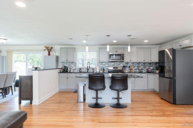 13 Berrywood Rd, Clay, NY 13090 - kitchen featuring appliances with stainless steel finishes, healthy amount of natural light, light wood-type flooring, backsplash, and recessed lighting