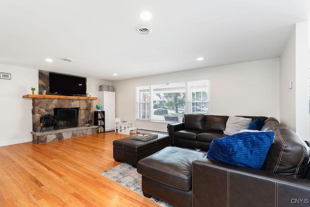 13 Berrywood Rd, Clay, NY 13090 - living area with wood finished floors, a fireplace, recessed lighting, and a baseboard radiator