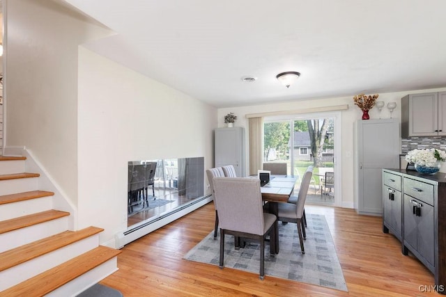 13 Berrywood Rd, Clay, NY 13090 - dining room with a baseboard radiator, light wood-style floors, and stairway