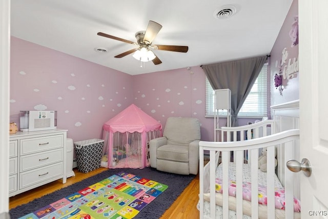 13 Berrywood Rd, Clay, NY 13090 - bedroom with light wood-style flooring, a nursery area, and a ceiling fan