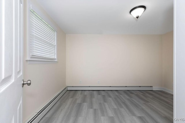 13 Berrywood Rd, Clay, NY 13090 - empty room with a baseboard heating unit and light wood-type flooring