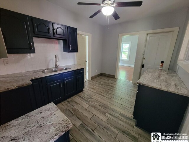 116 Park St, Jamestown, NY 14701 - kitchen featuring backsplash, ceiling fan, light wood-style flooring, and light stone countertops