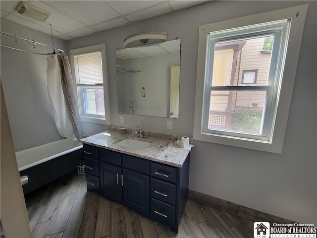 116 Park St, Jamestown, NY 14701 - bathroom featuring vanity, shower / bath combo, plenty of natural light, wood finished floors, and a drop ceiling