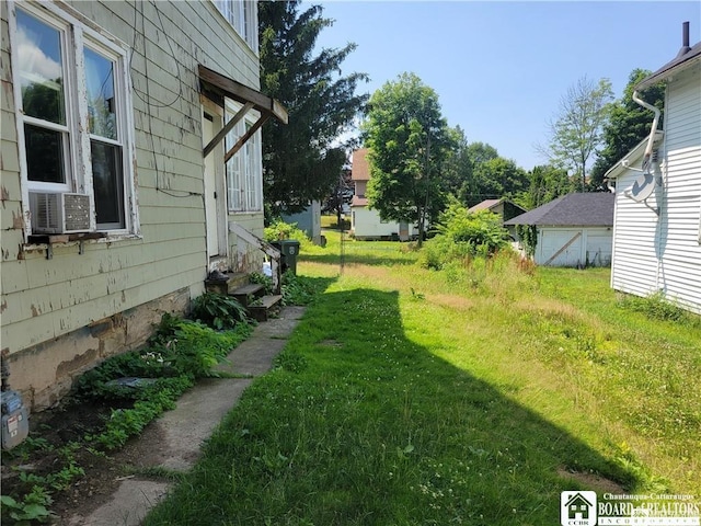 116 Park St, Jamestown, NY 14701 - view of green lawn featuring entry steps and cooling unit