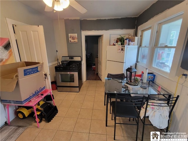 116 Park St, Jamestown, NY 14701 - kitchen featuring gas range, freestanding refrigerator, a ceiling fan, and light tile patterned floors