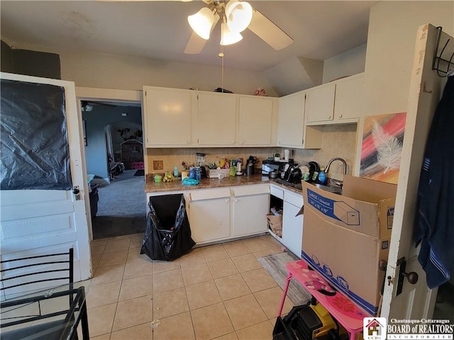 116 Park St, Jamestown, NY 14701 - kitchen with ceiling fan, white cabinetry, light tile patterned floors, lofted ceiling, and tasteful backsplash