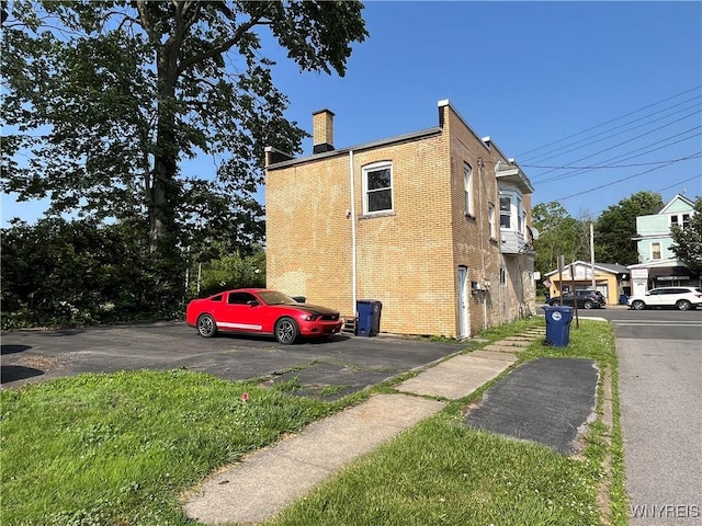 600 Cayuga Dr, Niagara Falls, NY 14304 - view of side of home featuring brick siding and a chimney