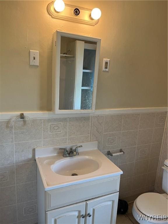 600 Cayuga Dr, Niagara Falls, NY 14304 - bathroom with tile walls, vanity, and wainscoting