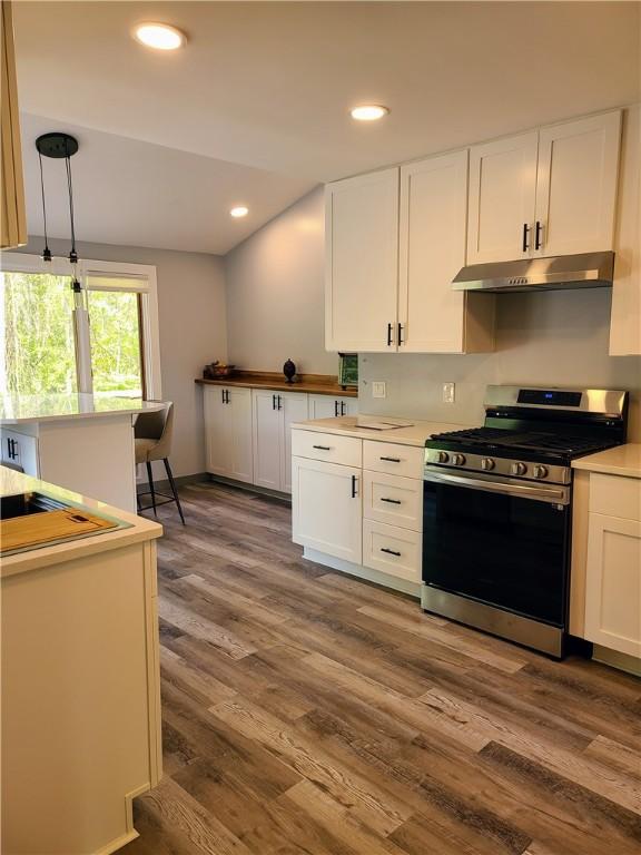 1324 New Seabury Ln, Victor, NY 14564 - kitchen featuring stainless steel gas range, under cabinet range hood, white cabinets, dark wood finished floors, and recessed lighting
