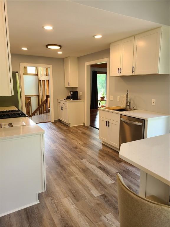 1324 New Seabury Ln, Victor, NY 14564 - kitchen featuring stainless steel dishwasher, white cabinetry, wood finished floors, light countertops, and recessed lighting