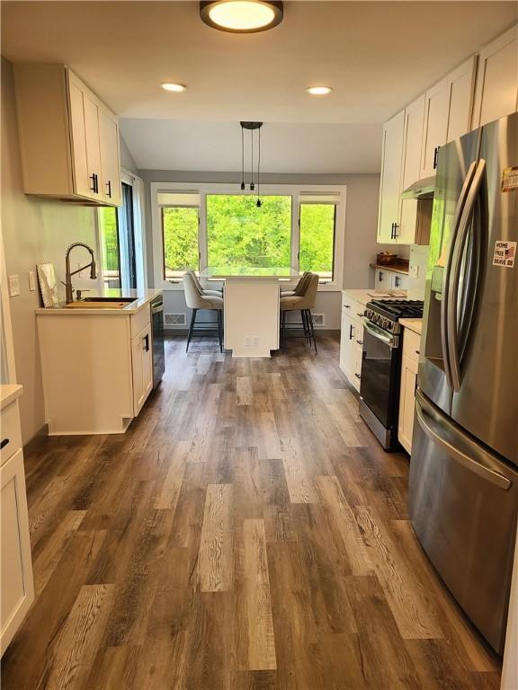 1324 New Seabury Ln, Victor, NY 14564 - kitchen with appliances with stainless steel finishes, white cabinets, light countertops, dark wood-type flooring, and recessed lighting
