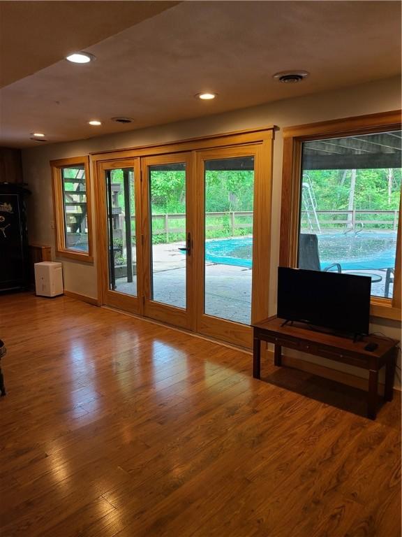 1324 New Seabury Ln, Victor, NY 14564 - unfurnished living room featuring healthy amount of natural light, wood finished floors, and recessed lighting
