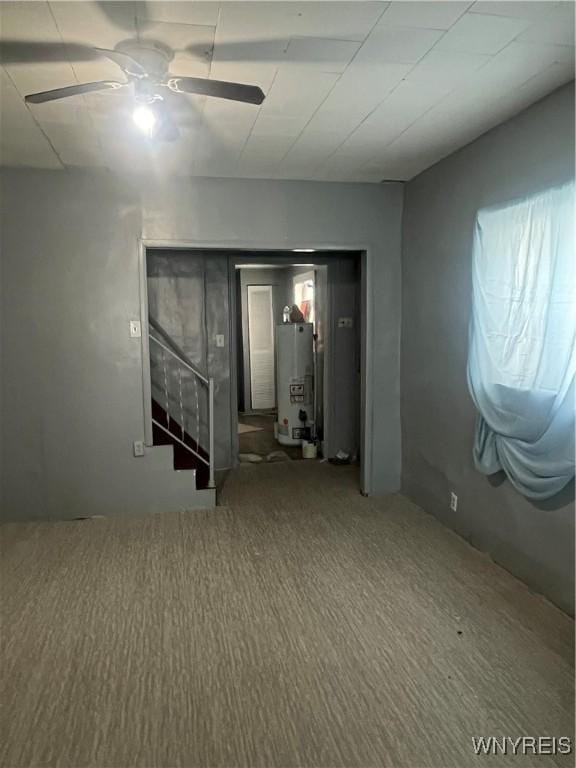 129 Liddell St, Buffalo, NY 14212 - below grade area featuring gas water heater, ceiling fan, carpet flooring, and stairway