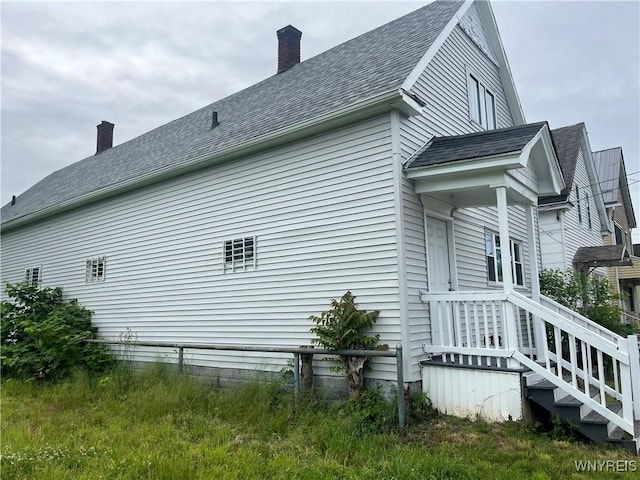 129 Liddell St, Buffalo, NY 14212 - view of side of home with a chimney and roof with shingles