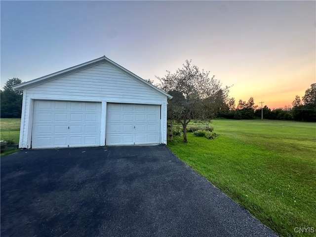 4076 State Highway 37, Morristown, NY 13669 - garage at dusk with a lawn and a detached garage