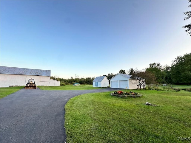 4076 State Highway 37, Morristown, NY 13669 - view of front of home featuring an outdoor structure, a front lawn, and a garage