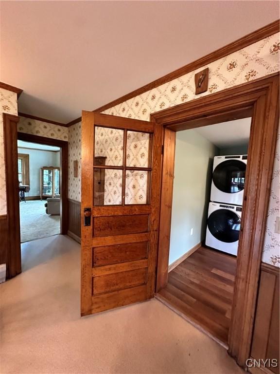 4076 State Highway 37, Morristown, NY 13669 - entryway featuring wallpapered walls, stacked washing machine and dryer, ornamental molding, wainscoting, and carpet floors