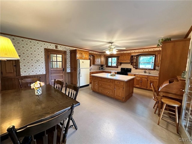 4076 State Highway 37, Morristown, NY 13669 - kitchen featuring freestanding refrigerator, black electric range oven, brown cabinetry, light countertops, and ceiling fan