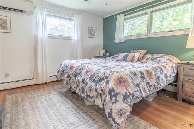 21912 Birch Ln, Watertown Town, NY 13601 - bedroom featuring a wall unit AC, wood finished floors, baseboard heating, and crown molding