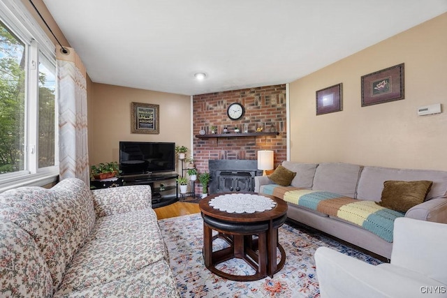 17 Hummingbird Pl, Clay, NY 13090 - living room with a brick fireplace and wood finished floors