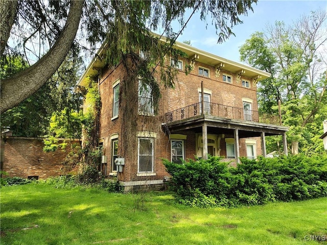 756 Herkimer Rd, Utica, NY 13502 - rear view of house with a yard, brick siding, and a balcony