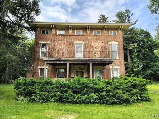 756 Herkimer Rd, Utica, NY 13502 - view of front of home with a balcony, brick siding, and a front lawn