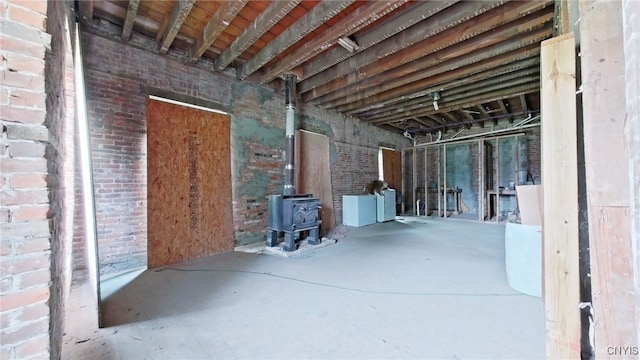 756 Herkimer Rd, Utica, NY 13502 - below grade area featuring washer and dryer, a wood stove, and brick wall