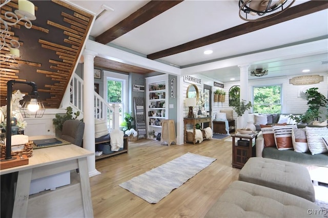31768 Wilton Rd, Rutland, NY 13619 - living area with decorative columns, beam ceiling, light wood-style flooring, healthy amount of natural light, and stairway
