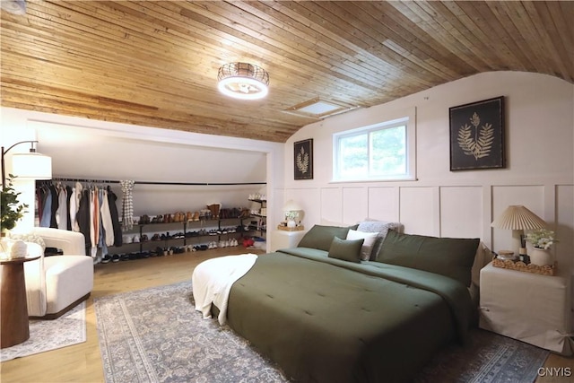 31768 Wilton Rd, Rutland, NY 13619 - bedroom featuring lofted ceiling, wood ceiling, a decorative wall, wood finished floors, and wainscoting